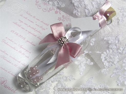 elegant wedding invitation in botle with pink bow
