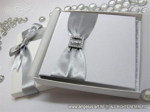 silver and white wedding rings pad in a book